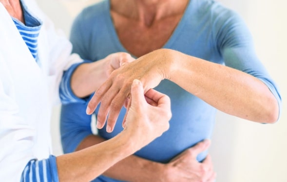 Rheumatologist examining a patient with rheumatoid arthritis